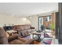 Inviting living room featuring a sliding glass door to the patio and hardwood floors at 6462 E Bates Ave, Denver, CO 80222