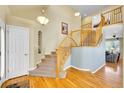 Bright foyer with hardwood floors, a staircase, and decorative lighting, creating a welcoming entrance at 5520 Morgan Way, Frederick, CO 80504
