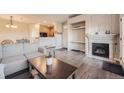 Living room featuring hardwood floors, a fireplace, and an open layout at 10437 W Hampden Ave # 202, Lakewood, CO 80227