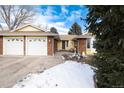 Brick ranch home with 3-car garage, and partially visible snow at 6926 S Saulsbury St, Littleton, CO 80128