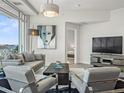 Beautiful living room with stylish furniture, modern decor, and an open doorway to the bedroom at 2001 Lincoln St # 1822, Denver, CO 80202
