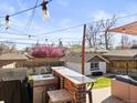 Outdoor kitchen and patio area with built-in grill, sink, and bar, perfect for entertaining guests at 3384 W 29Th Ave, Denver, CO 80211