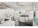 Bright kitchen featuring white cabinets, stainless steel appliances, and modern finishes at 3384 W 29Th Ave, Denver, CO 80211