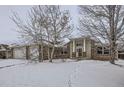 Brick home with a covered entryway and a snowy front yard at 646 N 13Th Ave, Brighton, CO 80601