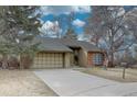 Charming single-Gathering home featuring a two-car garage and lush landscaping, perfect for suburban living at 7690 S Uinta Ct, Centennial, CO 80112