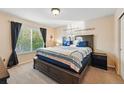 Comfortable bedroom with a large window, plush bedding, and warm, inviting decor at 4705 Andes St, Denver, CO 80249