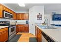 Well-equipped kitchen with stainless steel appliances, wooden cabinets, and functional layout at 4705 Andes St, Denver, CO 80249