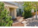 Inviting covered front entrance with stone walkway and landscaping at 10832 Montvale Cir, Highlands Ranch, CO 80130