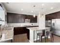Gourmet kitchen with stainless steel appliances, granite countertops, and a center island at 1382 Raindrop Way, Castle Rock, CO 80109