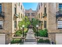 Inviting brick courtyard featuring mature landscaping, pathways, and decorative lighting at 960 N Sherman St # 3F, Denver, CO 80203