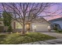 Charming one-story home features a two-car garage, manicured lawn, and welcoming front porch at 2556 E 131St Pl, Thornton, CO 80241