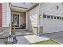 Inviting front porch with seating area and detailed brickwork, leading to a well-maintained home at 2556 E 131St Pl, Thornton, CO 80241