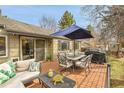 Inviting backyard deck featuring comfortable seating, a dining table with umbrella, and a grill at 5050 W 102Nd Ave, Westminster, CO 80031