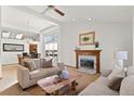 Living room with vaulted ceiling, fireplace, and large windows at 9436 Wickerdale Ct, Highlands Ranch, CO 80130