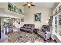 Bright living room featuring hardwood floors, vaulted ceiling, and large windows at 7835 Canvasback Cir, Littleton, CO 80125