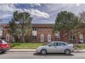 Charming brick townhouse with well-manicured lawn and sidewalk at 3614 W Radcliff Ave, Denver, CO 80236