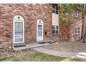 Close-up of brick townhouse entrances and landscaping at 3614 W Radcliff Ave, Denver, CO 80236