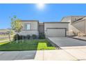 Beautiful single-Gathering home featuring a two-car garage, landscaped front yard, and stone veneer accents at 12724 Buffington Trl, Parker, CO 80134