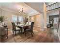 Formal dining room featuring hardwood floors, chandelier, and an elegant dining set at 24487 E Frost Dr, Aurora, CO 80016