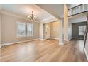 Spacious, light-filled living room features hardwood floors, large windows, and elegant chandelier at 24487 E Frost Dr, Aurora, CO 80016