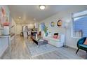 Open-concept living room boasts hardwood floors, abundant natural light, and flows seamlessly into the modern kitchen at 5863 N Boston St, Denver, CO 80238