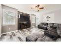 Comfortable living room features a ceiling fan, neutral paint, and stylish flooring at 334 Octillo St, Brighton, CO 80601