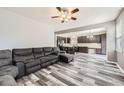 Open-concept living room seamlessly blends into the modern kitchen at 334 Octillo St, Brighton, CO 80601