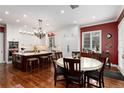 Bright kitchen with a large island, white cabinetry, hardwood floors, and a separate dining area at 4 Cherry Hills Farm Dr, Cherry Hills Village, CO 80113