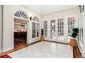 Bright hallway features large windows and doors, leading to a glimpse of the kitchen and outdoor space at 4 Cherry Hills Farm Dr, Englewood, CO 80113