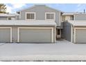 Townhouse exterior with snow-covered driveway and attached garage at 2795 S Lansing Way, Aurora, CO 80014