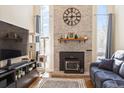 Living room featuring a brick fireplace and large windows at 2795 S Lansing Way, Aurora, CO 80014