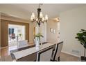 Dining room featuring chandelier, hardwood flooring, modern table setting with plants at 1146 W 144Th Pl, Westminster, CO 80023