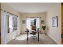 Bright office space with carpet flooring, 2 windows, and a modern desk setup at 1146 W 144Th Pl, Westminster, CO 80023