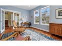 Comfortable living area with hardwood floors, rocking chairs, bright windows, and stylish decor at 2949 Emporia Ct, Denver, CO 80238