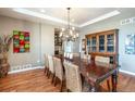 Formal dining area features a chandelier, long table, and built-in cabinet at 3392 Homestead Dr, Longmont, CO 80504