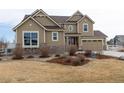 Front exterior of a two-story home with stone accents and three-car garage at 3392 Homestead Dr, Longmont, CO 80504