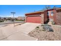 Street view of the townhome featuring a one car garage and rock landscaping at 2812 W Davies Dr, Littleton, CO 80120
