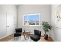 Comfortable living room area with a large window and modern furnishings at 2812 W Davies Dr, Littleton, CO 80120