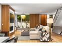 Bright living area with wood accents, a modern fireplace, and view into garden at 203 Garfield St, Denver, CO 80206