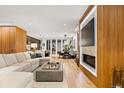 Open-concept living space featuring a fireplace and seamless transition to the dining area at 203 Garfield St, Denver, CO 80206