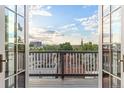 Scenic balcony view from home's doors showing rooftops and distant city at 2721 Curtis St, Denver, CO 80205