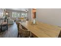 Rustic farmhouse dining table and chairs, hardwood floors at 7513 E Bates Dr, Denver, CO 80231