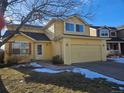 Inviting yellow two-story home with tidy landscaping, a 2-car garage, and a cozy entryway at 2746 E 132Nd Pl, Thornton, CO 80241
