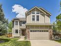 Charming two-story home with a well-manicured lawn and a two-car garage showcasing great curb appeal at 7659 Lebrun Ct, Lone Tree, CO 80124