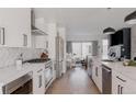 Bright, open kitchen featuring white cabinets, stainless steel appliances, and a quartz countertop island at 1322 Raleigh St, Denver, CO 80204