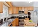 Efficient kitchen featuring stainless steel appliances, butcher block island, and wood cabinetry at 3715 Wolff St, Denver, CO 80212