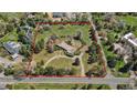 Aerial view of a large lot with a home surrounded by mature trees, outlined in red for property lines at 4480 S Franklin St, Cherry Hills Village, CO 80113