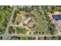 Aerial view of a house on large lot with mature landscaping and winding driveway at 4480 S Franklin St, Cherry Hills Village, CO 80113