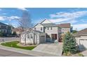 Charming two-story home with a landscaped yard, large driveway, and red front door at 3917 Starry Night Loop, Castle Rock, CO 80109