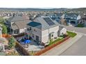 Back of house features a patio, hot tub, and solar panels on the roof at 3917 Starry Night Loop, Castle Rock, CO 80109